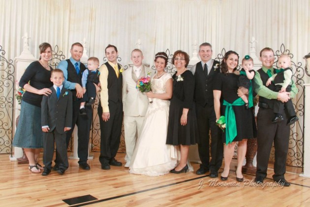 Josh with his family, my brother, my sister and her husband, my mom and dad, me and my family.  At my sister's wedding a few years ago.