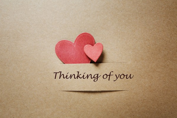 Thinking of you message with red paper hearts